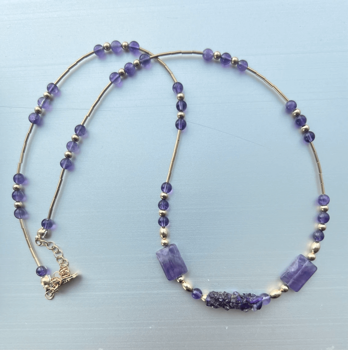 A beautiful caddisfly necklace made of amethyst.