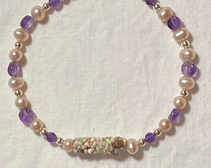 Shiny purple and opalescent white caddisfly jewelry bracelet.